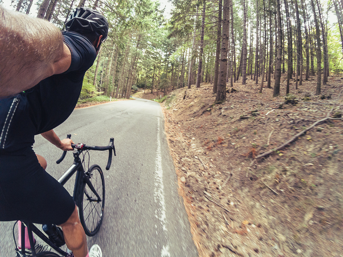 Climbing a mountain road on bicycle